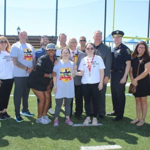 State Rep. Joseph McGonagle (far right) joined Police Chief Steven Mazzie and Special Olympics Massachusetts Inclusive School Programs Manager Makayla Parris (front left) and others.