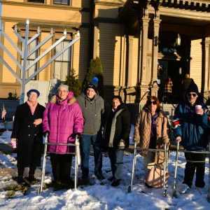 Members of Saugus Congregation Ahavas Sholom, pictured from left to right: Randy Sue Abber, Maureen Appel, Joseph Cole, Inex Cole, Regina Kaufman, John Kaufman and religious director Michael Simons assembled at the Menorah lighting on Dec. 26 at Saugus Town Hall. (Photo courtesy of Laura Eisener)