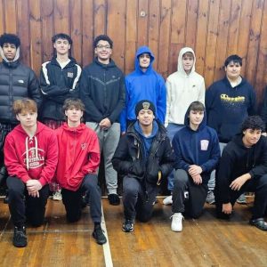 BEST TEAM PHOTO OF 2024: Members of the 2024 Saugus High School Sachems football team volunteered at the Saugus United Parish Food Pantry in the basement of Cliftondale Congregational Church, helping to make Thanksgiving brighter for needy local families.