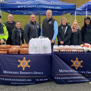 Middlesex Sheriff Peter J. Koutoujian and members of the Middlesex Sheriff's Office with some of the goods that were distributed on Saturday, November 18, 2023. (Photo courtesy of Middlesex Sheriff's Office)