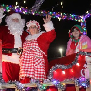 Santa, Mrs. Claus and an elf waved from their float.