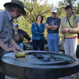 National Park Ranger Paul Kenworthy demonstrates water flow to a tour group at the tactile model during Trails and Sails events at the Saugus Iron Works on Sunday afternoon. (Courtesy Photo to The Saugus Advocate by Laura Eisener)