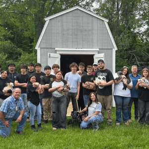 Northeast Metro Tech students, instructors and Superintendent David DiBarri stand together with staff from Eddie’s Ranch, a nonprofit animal rescue organization in Saugus, after students built a new shed for the ranch. The new shed is pictured at the rear. (Photos Courtesy Northeast Metro Tech)
