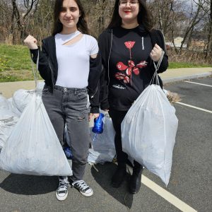 ON AN ENVIRONMENTAL MISSION: Zenera Shahu and Bella Vasi, copresidents of the newly formed Saugus Middle-High School Environmental Club, said they filled about three small trash bags of litter last Saturday during the second annual cleanup by Saugus Action Volunteers for the Environment (SAVE) in the parking lot of the Middle-High School. (Saugus Advocate photo by Mark E. Vogler)