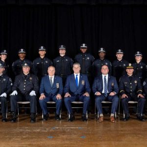 Members of the 53rd Basic Training Academy (standing) posed for a photo following their graduation. In the front row are Middlesex Sheriff Peter J. Koutoujian (center) alongside members of the Middlesex Sheriff's Office command and training staffs. (Photo by Josh London)