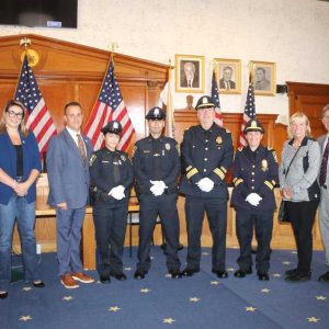Shown from left to right: State Representatives Jeffrey Turco and Jessica Giannino, Acting Mayor Patrick Keefe Jr., Mickaela Gonzaga, Alejandro Gomez-Catano, Executive Officer Sean Randall, Captain Maria LaVita, Ward 1 Councillor/City Council President Pro Tempore Joanne McKenna, Councillor At Large Anthony Zambuto and Ward 3 Councillor Anthony Cogliandro.