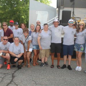 Shown kneeling, from left to right: Mark Natola, Karen Hurley. Middle row, shown from left to right: Michele Lucier, Stacey Scott, Melissa Curley, Laura Lauletta-Cadigan, Laura LoPriore, J’aime DiPlatzi, Andrew Lauria, Anthony Cruciotti, Marissa Cunningham, and Matt Cunningham. Back row, shown from left to right, are: Erich Straccia, Tom Weddleton, Carl Goss, Diane Moore, Dana Catizone, and Jim Summers.