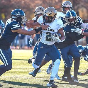 RECORD BREAKING RUN: Malden sophomore running back Jayden McGuffie (2) broke the 2,000-yard rushing barrier, the first player in school history to do so, on this run on Thanksgiving Day. Teammate senior Colin Okoth (4) blocked for him. (All Advocate Photos/Gino Spadafora)