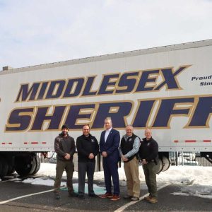 Middlesex County Sheriff Peter J. Koutoujian, Special Sheriff Amoroso Cefalo and Middlesex Jail & House of Correction Superintendent Michael P. Mahoney join Training Academy staff in front of the Mobile Training Center.