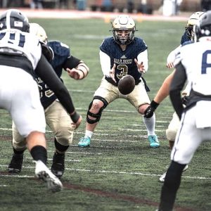 HERE’S THE SNAP: Malden High senior quarterback Aidan Brett (3) gets the snap-on Thanksgiving against Medford.