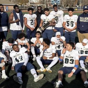 TORNADO PLAYERS and COACHES: Players from Malden’s offensive team and coaches gather to celebrate.