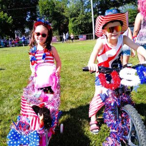 WHEELS OF JULY 4: Julianna and Anthony Merlina were among the kids who dressed up their doll carriages and bikes in a patriotic way.