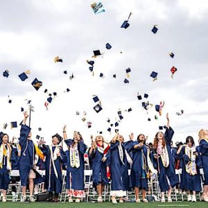 SKIES THE LIMIT: As their final act, the members of the Malden High Class of 2026 performed the traditional “hat toss” signifying their graduation from high school during their recent commencement ceremony at Macdonald Stadium. See inside for graduation highlights. (Advocate Photos/Henry Huang)