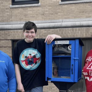 Evelyn Gayhart with her parents at the opening of the Book and Seed library.