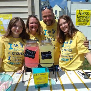 Proud parents Don and Susan Martelli with daughters Kayla and Jordan at their Alex’s Lemonade Stand outside their Dale St. home.  (Advocate photo by Neil Zolot)