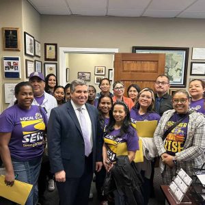 State Senator Sal DiDomenico in his office standing alongside SEIU members from his district.