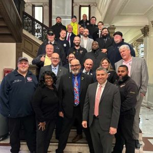 Senator Sal DiDomenico celebrating with Boston Carmen’s Union members and Keolis workers outside the Senate Chamber after the bill passed through the Senate (Courtesy photo)