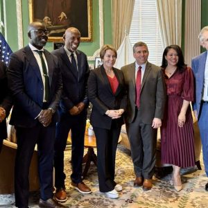 State Senator Sal DiDomenico, Geoffrey Canada, former Secretary of Education Paul Reville (second from right) and other supporters meeting with Governor Maura Healey in her office.
