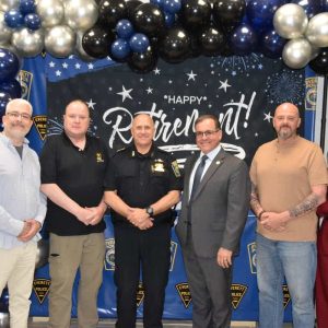 Detective Allen Peluso, Captain Paul Landry, Police Chief Paul Strong, Mayor Robert J. Van Campen, Lieutenant Larry Jedrey and Ward 2 Councillor Stephanie Martins celebrate during the Everett Police Dept. retirement ceremony.