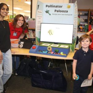 At right is Beachmont School kindergartner Aksel Smith with Northeastern University students Sahithi Gollakota (at left) and Malia Hendricks, who taught Aksel about pollinating plants.