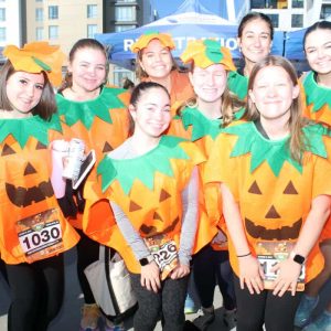 Bottom row, shown from left to right, are: Sari Nosteramo, and McKenzie Salcher dressed as pumpkins; Top row, shown from left: Gianna Meurer, Brianna Johnson, Lauren Ayres, Grace Watson, Alex Kitevski, and Lauren Turci.