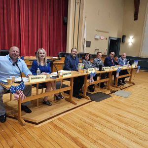 READY TO ROLL: The seven candidates for Board of Selectmen in the Nov. 7 town election prepared for the start of Wednesday’s candidates’ forum sponsored by the local environmental group SAVE. Pictured from left to right are Sebastian DiModica, Debra Panetta, Sandro Pansini Souza, Corinne Riley, Michael Serino, Anthony Cogliano and Jeffrey Cicolini. (Saugus Advocate photo by Mark E. Vogler)