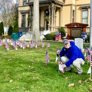 REMEMBERING A VET: In the Saugus Town Hall Field of Flags, Saugus Advocate Editor Mark E. Vogler checks out his twin brother’s flag. Sergeant Lance A. Vogler was a U.S. Air Force Vietnam Veteran who was killed in a motorcycle accident in his hometown of Swansea on Memorial Day in 1978. (Photo courtesy of Joanie Allbee)