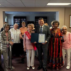 Mary Gallo (left of Mayor), Mayor Gary Christenson and friends at Mary’s celebration.