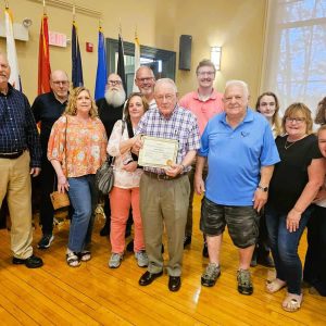 Retiring Conservation Officer Frank McKinnon was surrounded by family members and his friends on the Conservation Commission after he received a special citation from the selectmen. (Saugus Advocate Photo by Mark E. Vogler)