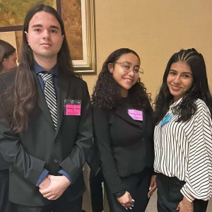 Shown from left, Nikolas Lacerda, of Revere, Kashayla Valentin, of Melrose, and Janely Lizardo, of Chelsea, stand together after winning 4th Place in Project Management Financial Literacy at the district-level DECA competitions. (Courtesy Northeast Metro Tech)