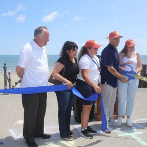 YES, WE’RE OPEN: Shown at the official ribbon-cutting for the Farmer’s Market on Revere Beach, from left to right: Adrienne Maguire, School Committee Secretary John Kingston, Ward 5 Councillor Angela Guarino-Sawaya, Dept. of Public Health Healthy Living Program Coordinator Samanda Lumaj, Mayor Patrick Keefe, Dept. of Public Health Director Lauren Buck and Councillor-At-Large Robert Haas. (Advocate photo by Tara Vocino)