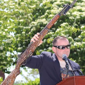 Last year’s Keynote Speaker, author and veteran Andrew Biggio displayed a rifle that more than 300 veterans have signed.  (Advocate file photo)