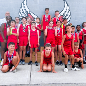 SAVORING THEIR VICTORIES: A group from the Saugus Sachems Summer Track Camp at the end of the Summer Showdown in Cranston, R.I., displaying some of their hard-earned medals and ribbons ahead of learning they finished third as a team amongst the nearly 20 teams that competed. (Courtesy Photo to The Saugus Advocate)