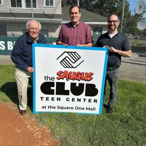 SPONSORING HOMETOWN BASEBALL: Shown left to right are World Series Park Superintendent Bob Davis, Boys & Girls Clubs of Stoneham and Wakefield CEO Adam Rodgers and Director of Development Anthony Guardia with the sign that is displayed at World Series Park. (Courtesy Photo to The Saugus Advocate)