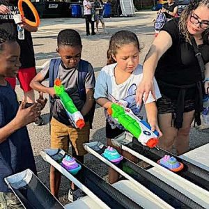 SQUIRT CITY: Malden students jockeyed for position at the “Squirt Races” game, using water from squirt guns to push their vessels along the track – one of the many interactive games on-site at the first-ever “Back to School Fest” – which was held as a districtwide, citywide event at Malden High School.