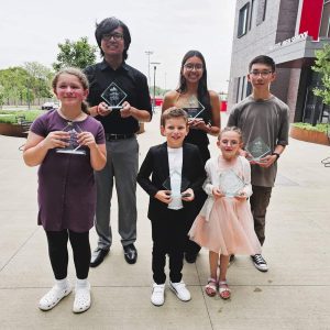 STUDENT ROLE MODELS: This year’s “Unsung Hero Award” winners showed their trophies after being recognized during a special presentation this week at the Saugus Middle High School Complex. Pictured from left to right: Front row: Reese DelMuto, Pedro Amarilla and Gwen Thurston; back row: Jordan Chantha, Kathryn De Souza and Luis Fung Chen. Missing from the photo is Victoria Vannah. (Saugus Advocate photo by Mark E. Vogler)