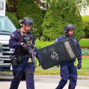 SWAT teams from the Northeastern Massachusetts Law Enforcement Council (NEMLEC) are shown approaching a Saugus home on Monday morning after an emotionally distressed man had barricaded himself in a bedroom. (Courtesy photo to The Saugus Advocate by Michael Layhe)