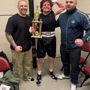 CHAMP CELEBRATES: Pictured from left to right, Coach Travis Gamberdella, Sam LoRusso and Coach Mike Penta.