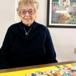 Sandy St. Clair making her last puzzle in the Community Room at Heritage Heights in Saugus. (Photo courtesy of Joanie Allbee)