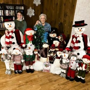 Saugus Housing Authority residents Debbie Elliott and Louise Martin loved the company of Guy’s Snowville snowmen family. (Courtesy photo of Joanie Allbee)