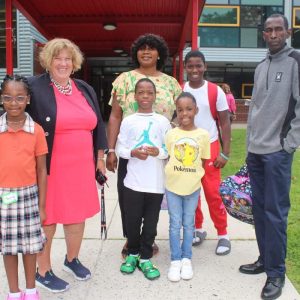 Shown from left to right: Second-grader Sophia Adejobi, 7, Principal Maureen Lueke, second-grader Caleb Adejobi, 7, second-grader Anaika Thelamy, 7, fifth-grader Franklin Adejobi, 10, their mother, Fisayo Adejobi, and Anaika’s father, James Themaly. (Advocate photos by Tara Vocino)