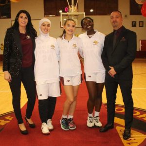 Shown from left to right: Assistant Coach Brittany Hazelton and seniors Rim Badaoui, of Malden, Aya Abbassi, of Revere, and Breana Immaculate Nansamba, of Malden, and Head Coach Rick Pulsifer.