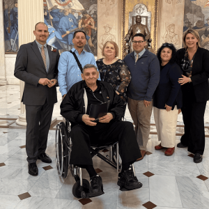 Shown during the Inaugural Military Appreciation Day event at the State House last week, from left to right, are City Council President Marc Silvestri, Richard Serino Jr., Trudy Serino, Richard Serino III, Gina Serino, State Representative Jessica Giannino and honoree Richard Serino, Sr. (in the front). (Courtesy of State Rep. Giannino’s Office)
