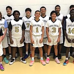 The Malden 7th Grade Travel Boys Basketball Team opened its 2023-2024 season with a 45-31 victory over Medford on Sunday. Above, the team is shown with coaches, including Head Coach Justin Bell (far left). (Courtesy/Malden High School Athletics)