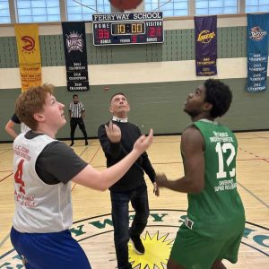 JUMP BALL: Ward 7 City Councillor Chris Simonelli, a sponsor of the Malden Neighborhood Basketball League, is shown throwing the ceremonial jump ball at the start of the recent game between the Bullets and Celtics.  (Photo courtesy of MNBL)