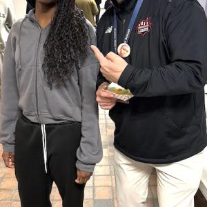 SHE’S THE STATE CHAMP! Malden High School State Champion (300M Dash) Khadijah Diagne (left) was congratulated in the hall outside of the lunch area by MHS Principal Chris Mastrangelo (right) this week. (Courtesy/Malden High School)