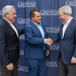 State Representative Joseph McGonagle, Everett Mayor Carlo DeMaria and Greystar’s Managing Director, Gary Kerr, celebrate the opening of Mason, a 330-unit residential building in Everett’s Commercial Triangle District. Mason is the first community to deliver as part of Greystar’s $730 million investment in the city, which will bring 1,900 new housing units, more than 100 affordable, to the neighborhood. (Photo credit: Melissa Ostrow)