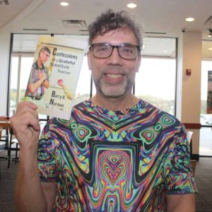 Author Barry Norman held up “Confessions of a Grateful Substitute Teacher” during an interview on Sunday afternoon at Panera Bread in Saugus. (Advocate photo by Tara Vocino)