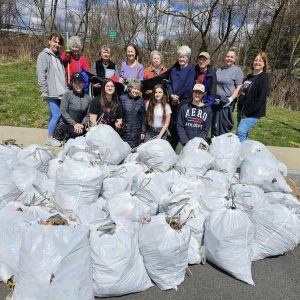 THE CLEANUP CREW: The 14 volunteers who turned out last Saturday in the back of the parking lot at Saugus Middle-High School to clean up a trail of trash for the second annual cleanup of the school complex organized by Saugus Action Volunteers for the Environment. (Saugus Advocate photo by Mark E. Vogler)