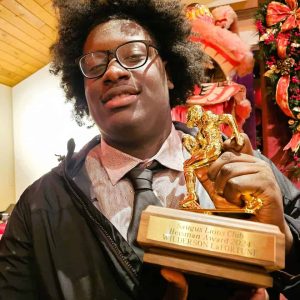 THE HIGHLIGHT OF HIS CAREER: Saugus High School senior Wilderson LaFortune beamed with pride after being awarded the Saugus Lions Club’s “Heisman Award” last Wednesday night. (Saugus Advocate photo by Mark E. Vogler)